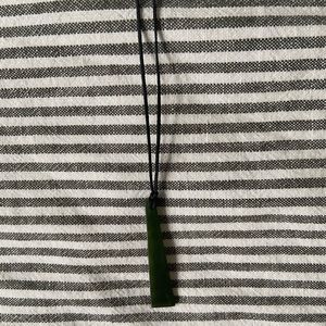 Green stone necklace with black adjustable cord.